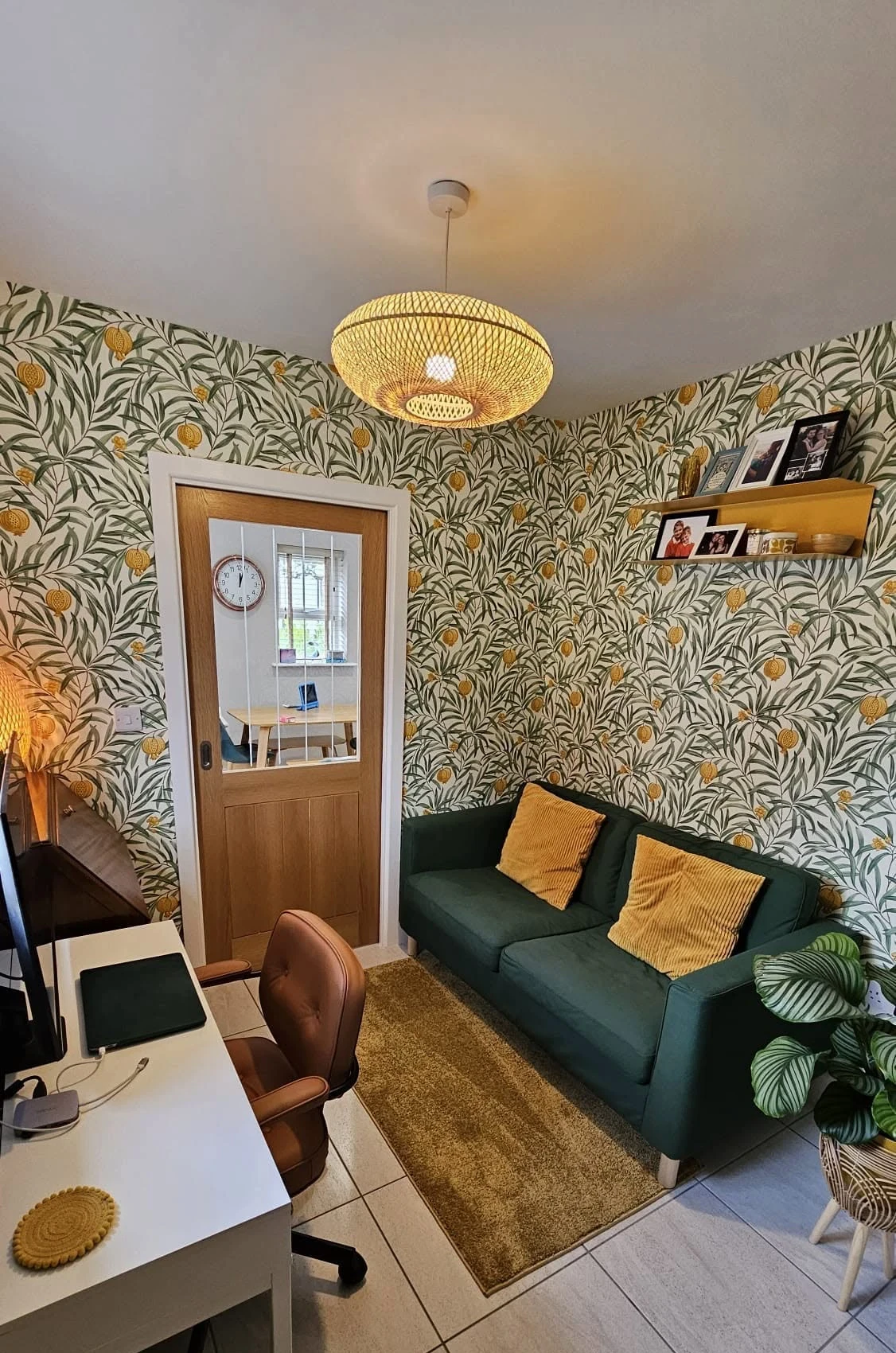 Snug with botanical wallpaper and fitted shelving, built by RGS Joinery and Building