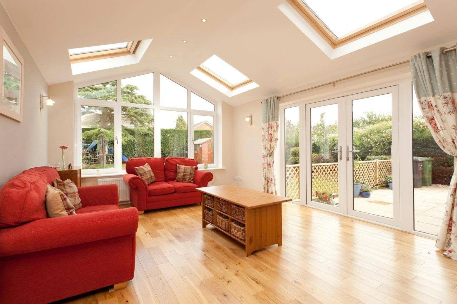 Bright vaulted rear extension lounge with roof windows, built by RGS Joinery and Building